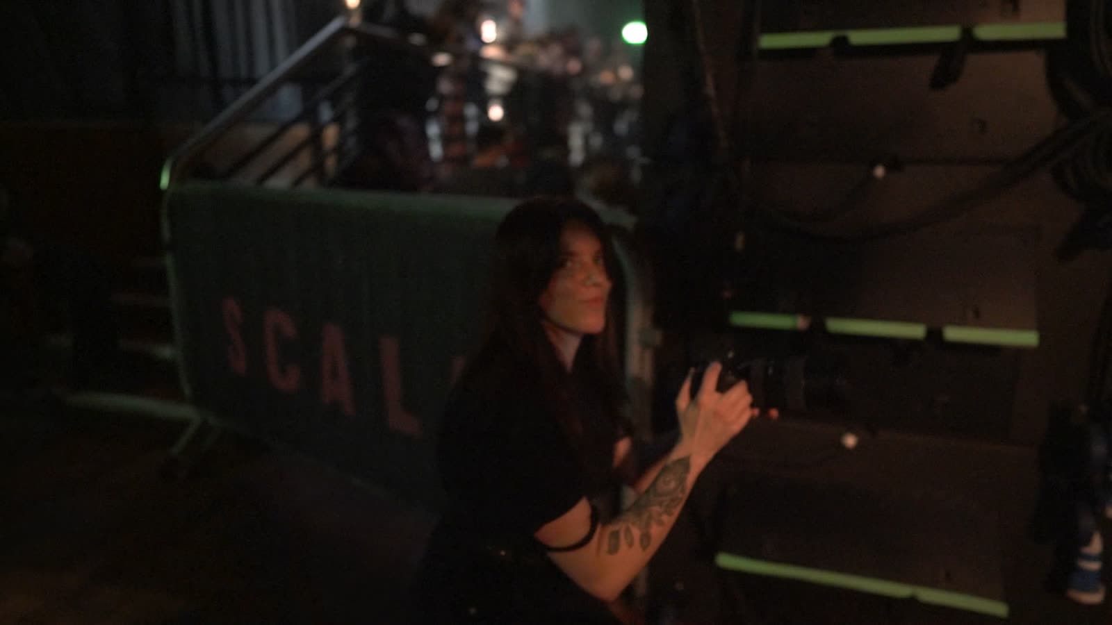 Crew member operating a camera backstage at Scala, London
